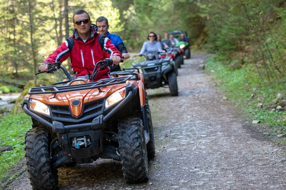 Group of people driving 4 wheelers and ATVs